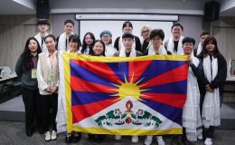 Participants taking part in the Tibet Network Meeting in Taiwan holding a Tibetan flag